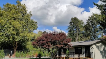 A cabin with a picnic table and a sign indicating it is Cabin 2.