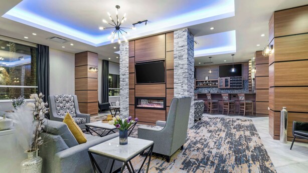 A modern living area with a fireplace, seating, and a bar area. - Best Western Premier Route 97 Vernon (Vernon)