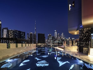 A rooftop pool with a cityscape view, including a prominent skyscraper. - Hyde Hotel Dubai (Dubai)