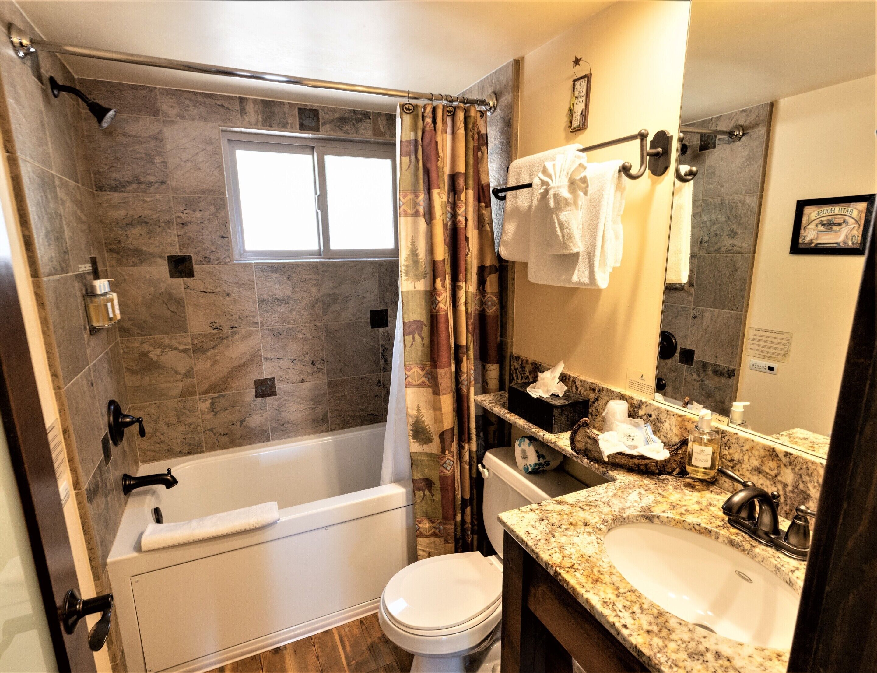 A bathroom with a bathtub, toilet, sink, and a shower curtain.