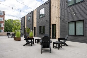 A modern outdoor patio with seating and planters. - Cozy Nashville Home • Walk to Vandy (nashville)