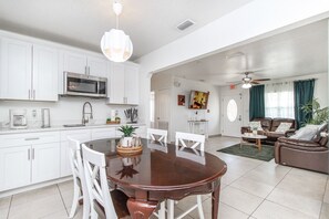 Cozy living space with a dining area, kitchenette, and comfortable seating for relaxation.