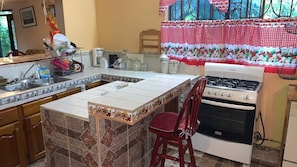 Fridge, oven, coffee/tea maker, cookware/dishes/utensils