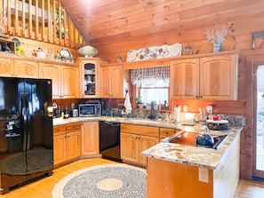 Enjoy cooking in this well-equipped kitchen with a refrigerator, microwave, sink, and dishwasher.