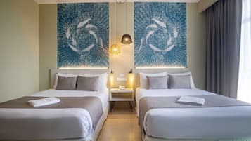 A hotel room with two beds, a nightstand with a phone, and a wall with a blue abstract design.