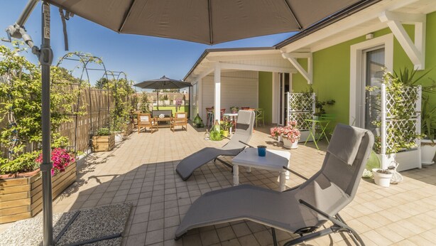 An outdoor patio with a covered seating area, a table, and chairs. - Double/twin room with bathroom and king size bed near Pescara airport (Pescara)
