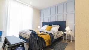 A hotel room with a bed, a desk with a chair, a small exercise ball, a bedside table with a lamp, and a nightstand with a phone. - Double/twin room with bathroom and king size bed near Pescara airport (Pescara)