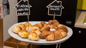 Ein Teller mit Croissants und Calzone, mit Schildern, die ihre Namen zeigen.