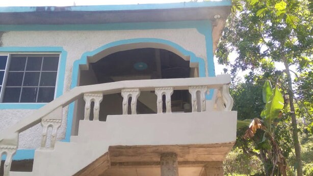 A building with a balcony and a staircase.