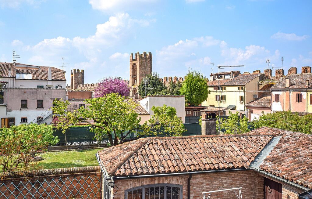 A historic town with traditional buildings, a prominent tower, and a well-maintained garden.