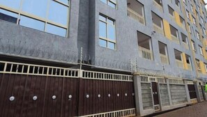 A multi-story building with a grey facade, large windows, and balconies. - The Studio | Nairobi | 5* Luxury (UN & Two Rivers) (Ruaka, Nairobi)