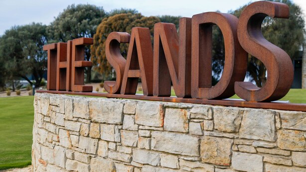 A stone wall with large, rust-colored letters spelling "THE SANDS". - The Sands Torquay (Torquay)