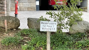 A sign indicating a reserved area for housing 1 and 1.3 units.