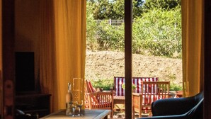 An indoor seating area with a table, chairs, and a TV. - Sunny Escape to Serenity (Fraissé-Des-Corbieres)