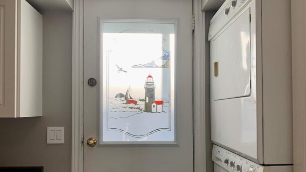 A laundry room with a door featuring a maritime scene. - A bright suite with lots of room for fun and relaxation, just 5 minutes from the Halifax ferry! (Dartmouth)