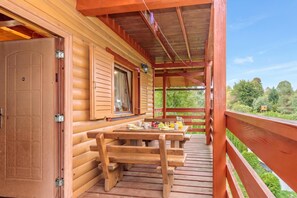 A wooden deck with a picnic table and benches, overlooking a forested area. - Chalet With Private Whirlpool And Sauna (Brod Moravice)