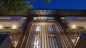 A hotel entrance with a sign reading "STAY365 APART HOTEL" and vertical wooden slats. - Stay 365 Heraklion Apart Hotel (Heraklion)