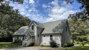 A two-story house with a front porch, a driveway, and a well-maintained lawn. - Country Quiet 3 Bedroom 2 Bath Tranquil Space! (Millsboro)