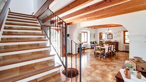 A wooden staircase with a metal railing leading to a dining area with wooden furniture and a view of the dining room. - Finca Can Pontico - Four Bedroom House, Sleeps 6 (Pollensa)