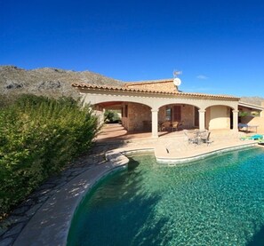 A house with a swimming pool, a patio, and a mountain backdrop. - Can Jaume la Font by Vida Villas, walk to town (Pollença)