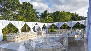 An outdoor wedding reception area with round tables, chairs, and draped white canopies. - Saint Patrick Palace - Wedding-Ready Luxury Estate w/ Pool & Guest Cottage (Davie)