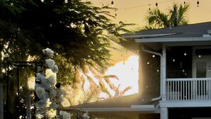 A wedding setup with a white floral arch and a table with a white tablecloth. - Saint Patrick Palace - Wedding-Ready Luxury Estate w/ Pool & Guest Cottage (Davie)