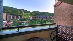 A balcony with a view of a resort area, including buildings and a lake. - Large, Welcoming Condo With Incredible Views - WL406 by Redawning (Copper Mountain)