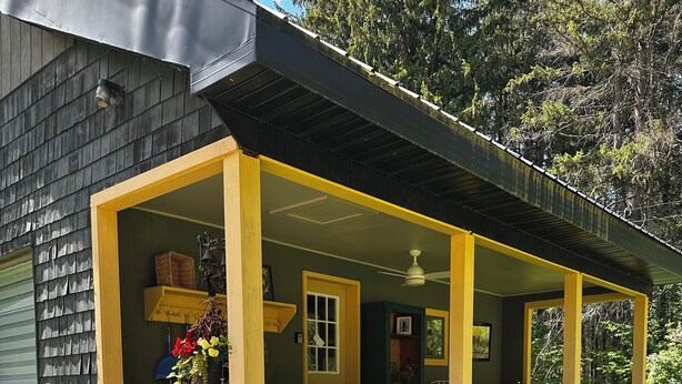 A house with a porch, number 315, and a small garden area with plants. - SKI, FISH, GOLF, RAFT, HIKE, HUNT, ATV ride, RELAX, 4 bdr home on wooded ADK lot (Malone)