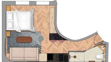 A hotel room layout with a bed, sofa, bathroom, and kitchenette.