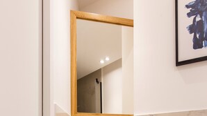 A bathroom with a white sink, a mirror, and a framed artwork on the wall. - St Georges - Superb studio in the heart of Paris (Paris)