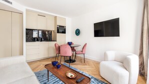 Ein modernes Wohnzimmer mit Küche, Essbereich und Sitzgelegenheiten.