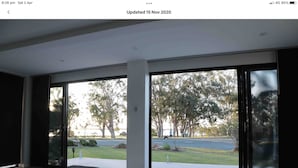 A modern interior with large sliding glass doors leading to a covered outdoor area. - Water front Property with magical sunsets and water front walking and bike paths (Banksia Beach)