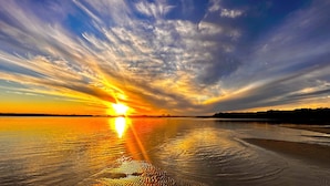 A sunset over a calm body of water with a clear sky. - Water front Property with magical sunsets and water front walking and bike paths (Banksia Beach)