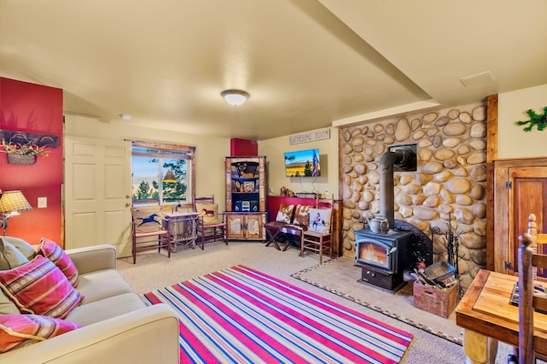 Warm up beside the wood stove and enjoy a quieter corner of the home in this spacious lower-level gathering room.
