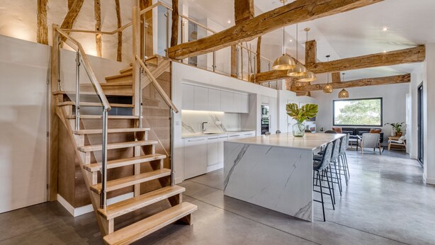 A modern kitchen with a marble island, wooden staircase, and exposed wooden beams. - Villa Kundalini - Three Bedroom Villa, Sleeps 8 (Ambres)