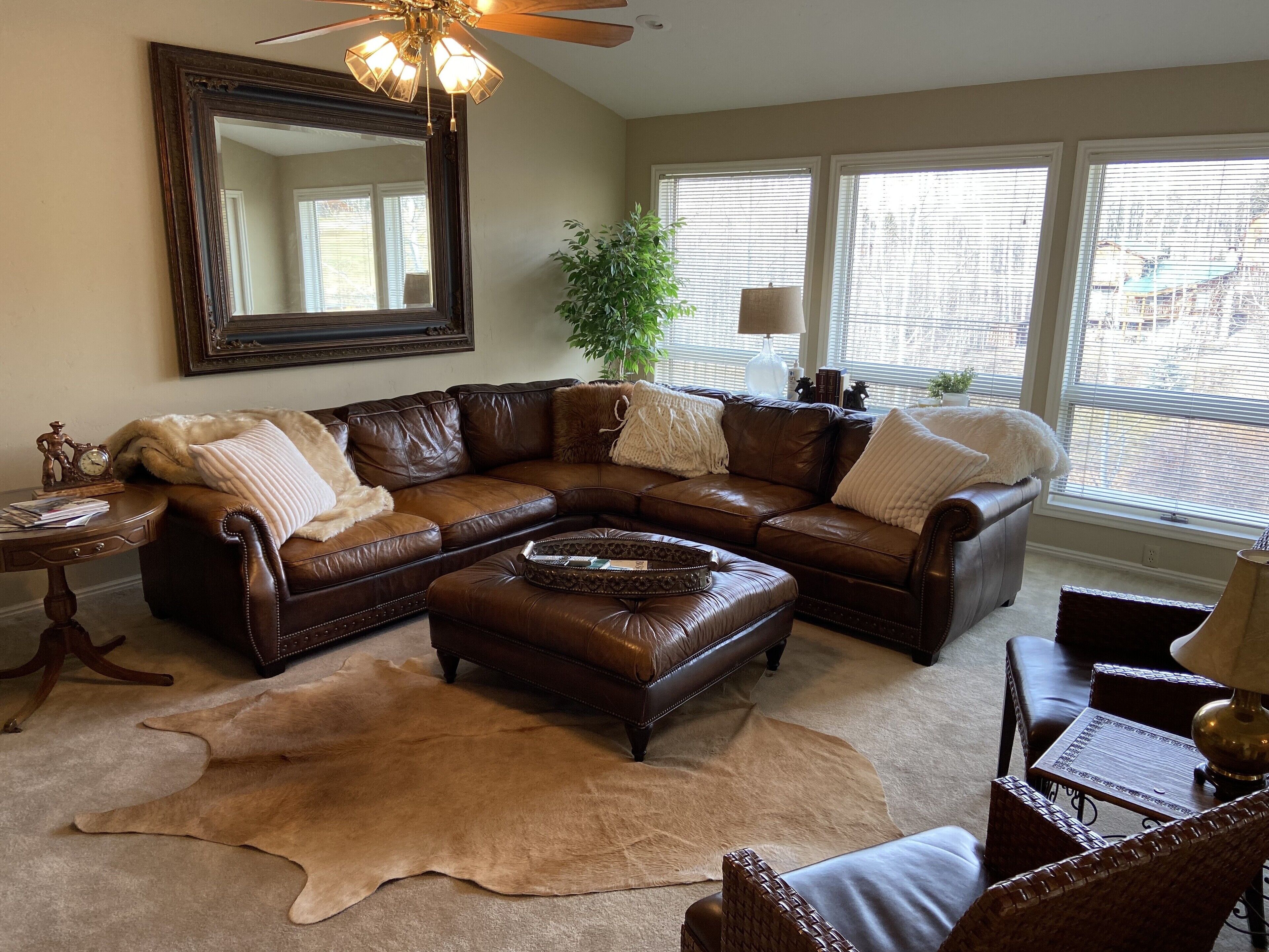 Living room with walk out. Large tv and leather sectional for big group. 
