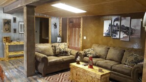 A cozy living room with a wooden coffee table, two sofas, and a patterned rug.