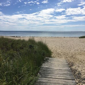 A wooden boardwalk leading to a sandy beach with a clear sky. - 4 Br Padenarem Retreat l Private Beach (South Dartmouth)