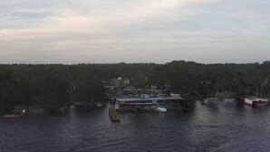 A waterfront view with a dock and a building with a blue roof. - Beautiful  Water Front  Cabins (Georgetown)