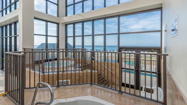 A pool area with a hot tub, stairs, and a view of the ocean. - Beachfront Condo w Private Balcony in Orange Beach, AL at PHX I (Orange Beach)