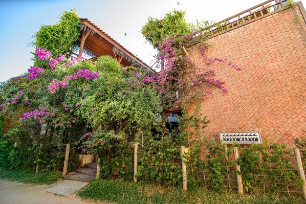 A traditional building with a brick wall and a wooden gate.