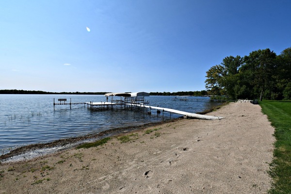 Beach and dock on level lot with sand for outdoor fun