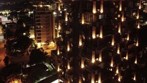 A high-rise building with illuminated windows at night. - Beautiful view, 13th floor, modern, exclusive and comfortable apartment. (Santiago De Los Caballeros)