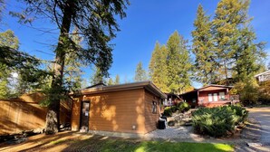 A cabin with a small porch and a garage.