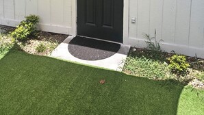 A black front door with a small porch and a mailbox.