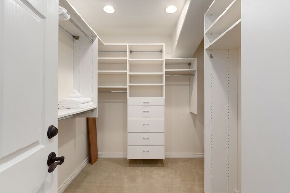 A walk-in closet with open shelves, drawers, and hanging space. - Stunning Ocean-view Oasis w/ Pool, Spa & Patio (San Diego)