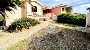 A two-story house with a stone pathway leading to the entrance.