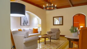 A living room with a sofa, armchairs, a coffee table, and a chandelier. - Nukari Quinta Boutique (Jala)