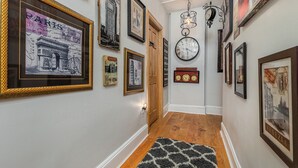 A hallway with framed pictures of Paris, London, and Venice. - Majestic & Relaxing Home w/ 3 Beds Pool Table Bar! Sleeps 8 (Dubuque)