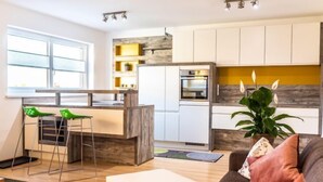 A modern apartment with a kitchen, dining area, and living room. - Apartment Sabine by Interhome (Oberperfuss)